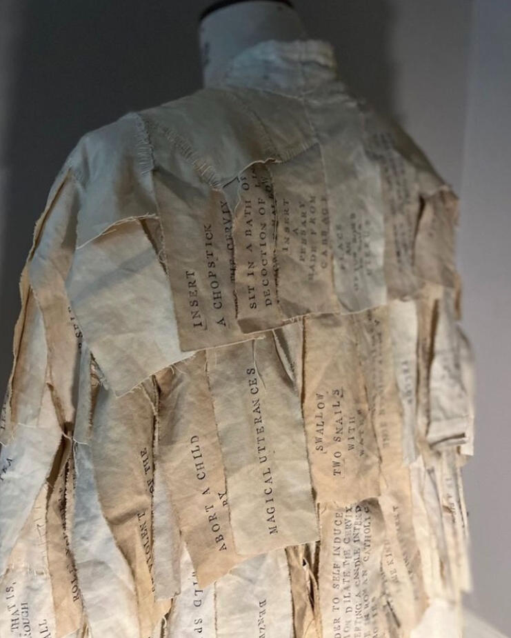Coat of the Cruel Mother. Old teastained cotton sheets, handprinted with almost 300 methods of abortion used by women over the centuries. 2024 Exhibited at The Winchester Gallery 2025